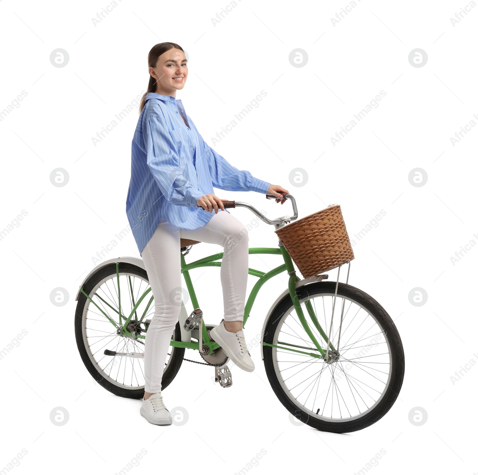 Photo of Smiling woman on bicycle with basket against white background