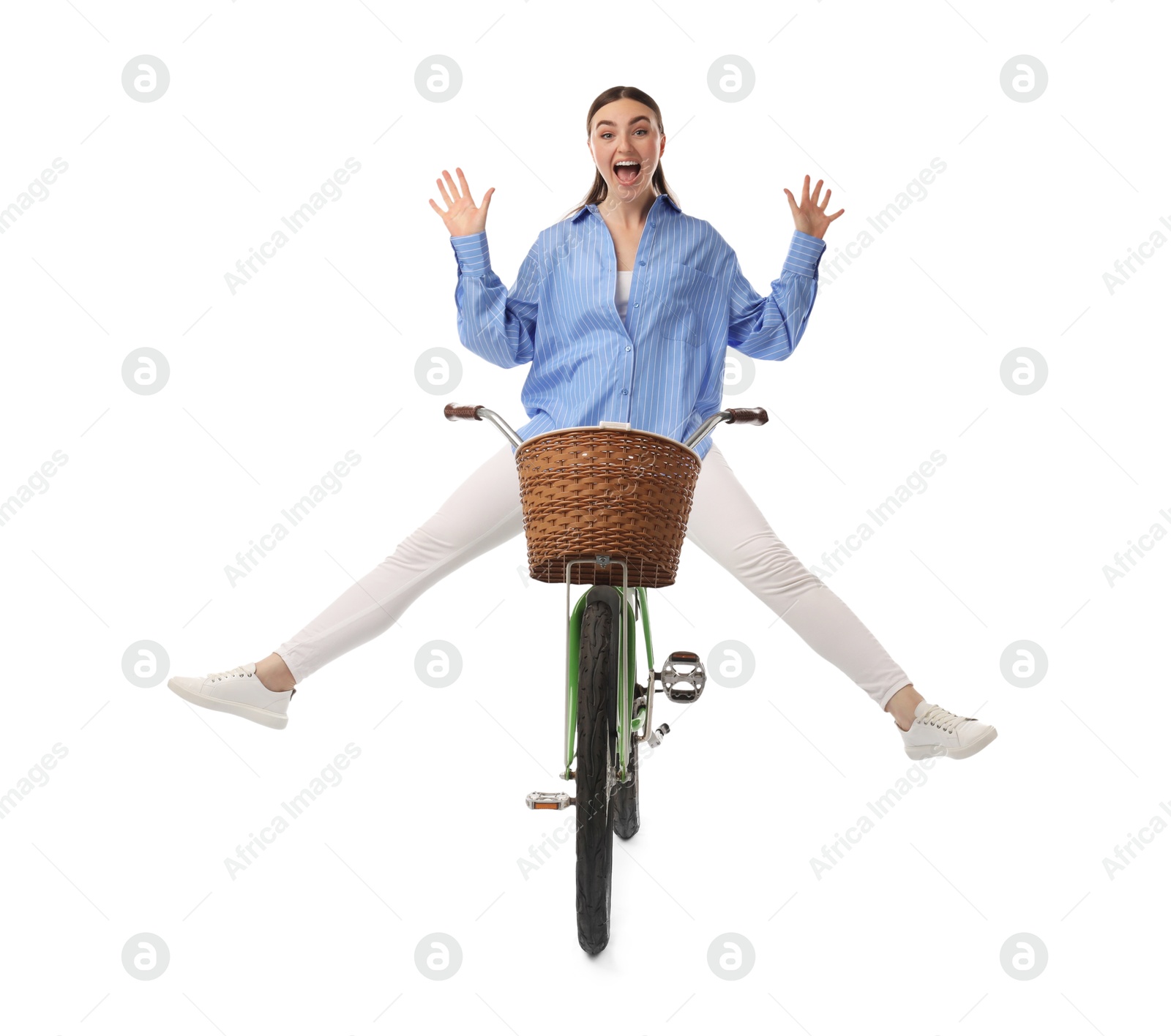 Photo of Emotional woman having fun while riding bicycle with basket against white background