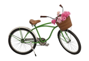 Photo of Bicycle with basket of pink peony flowers isolated on white