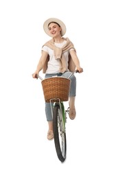 Smiling woman riding bicycle with basket against white background