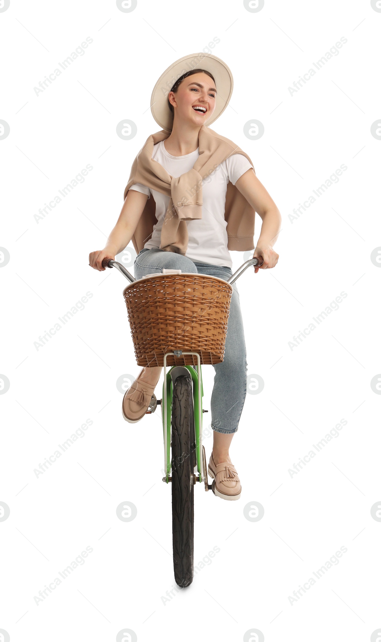 Photo of Smiling woman riding bicycle with basket against white background