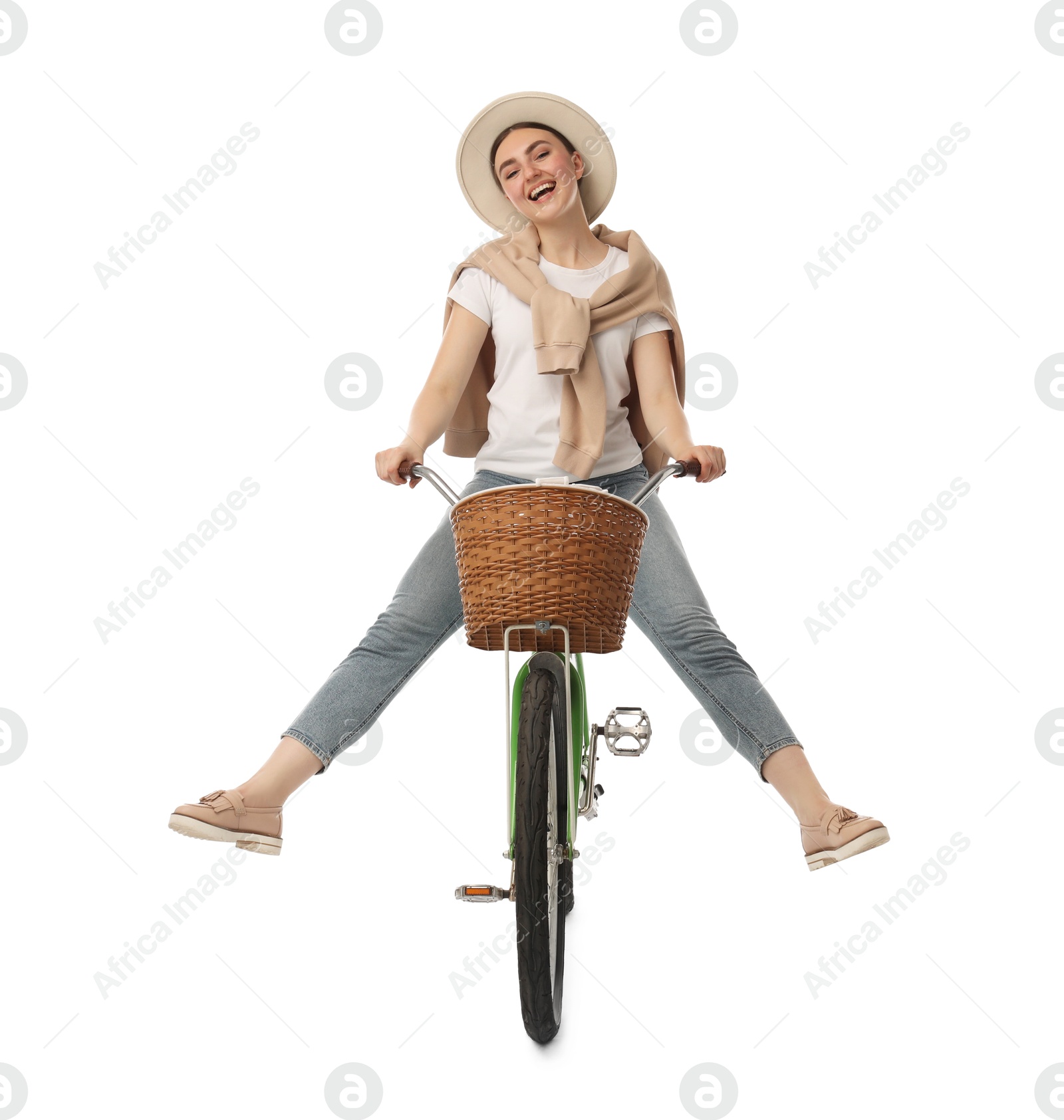 Photo of Smiling woman having fun while riding bicycle with basket on white background