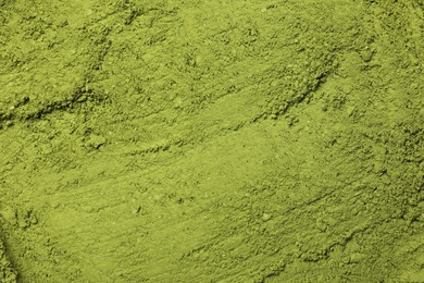 Green matcha powder as background, top view