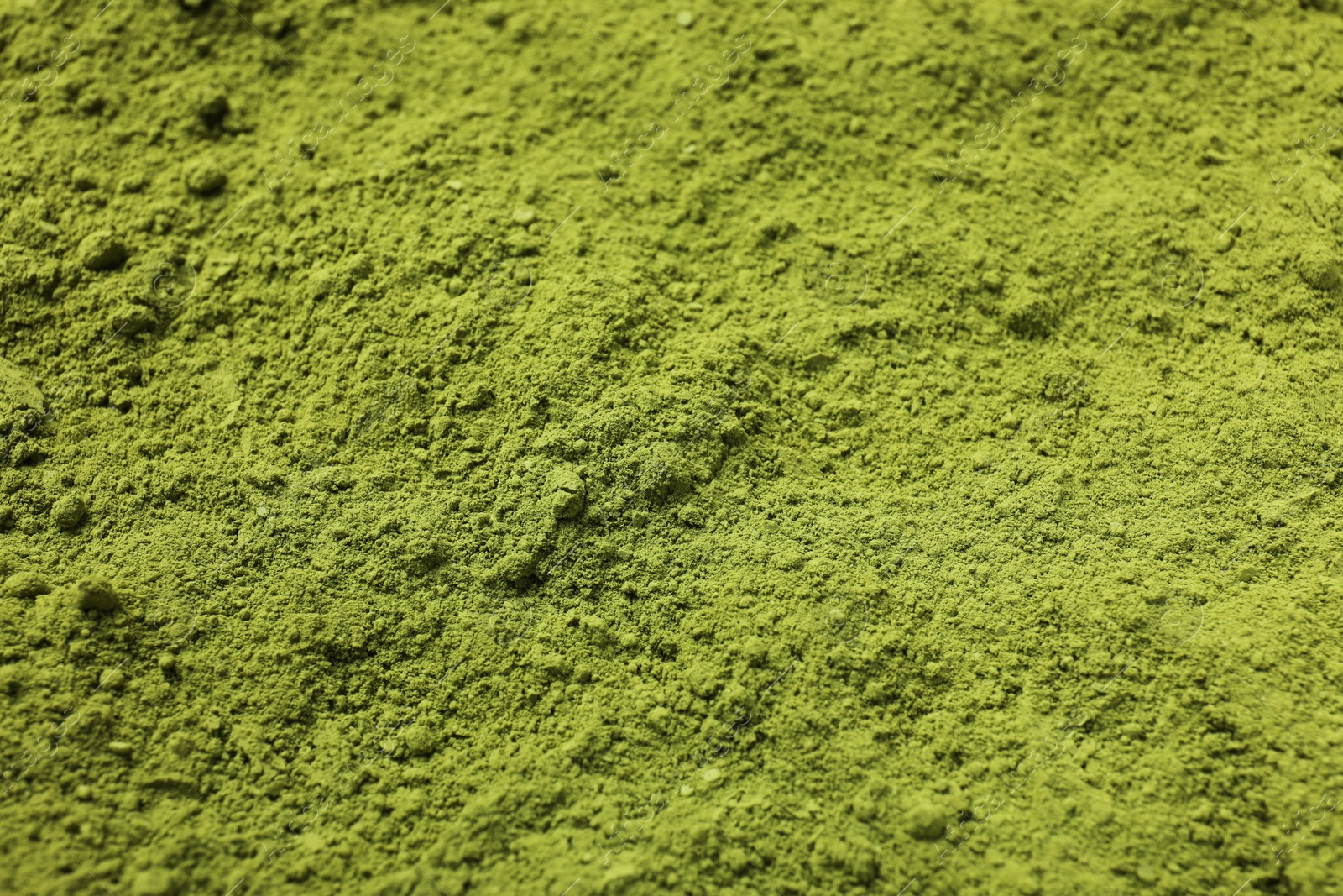 Photo of Green matcha powder as background, closeup view