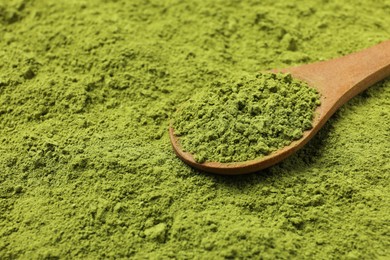 Photo of Spoon and green matcha powder, closeup view