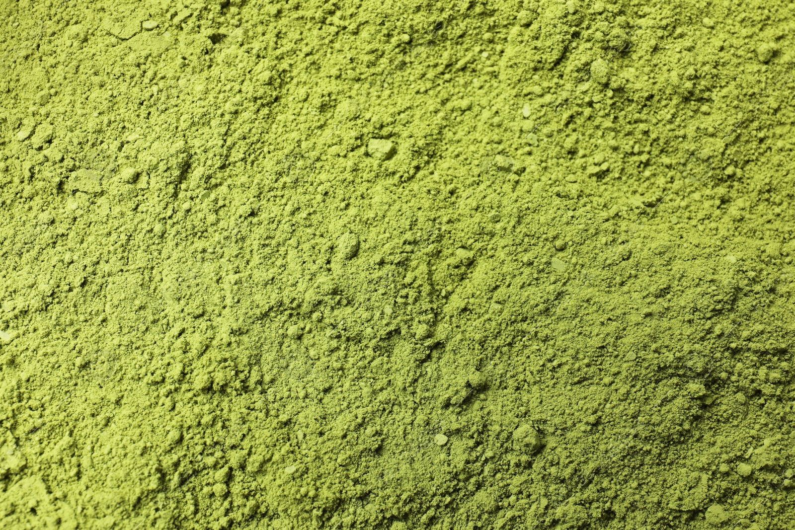 Photo of Green matcha powder as background, top view