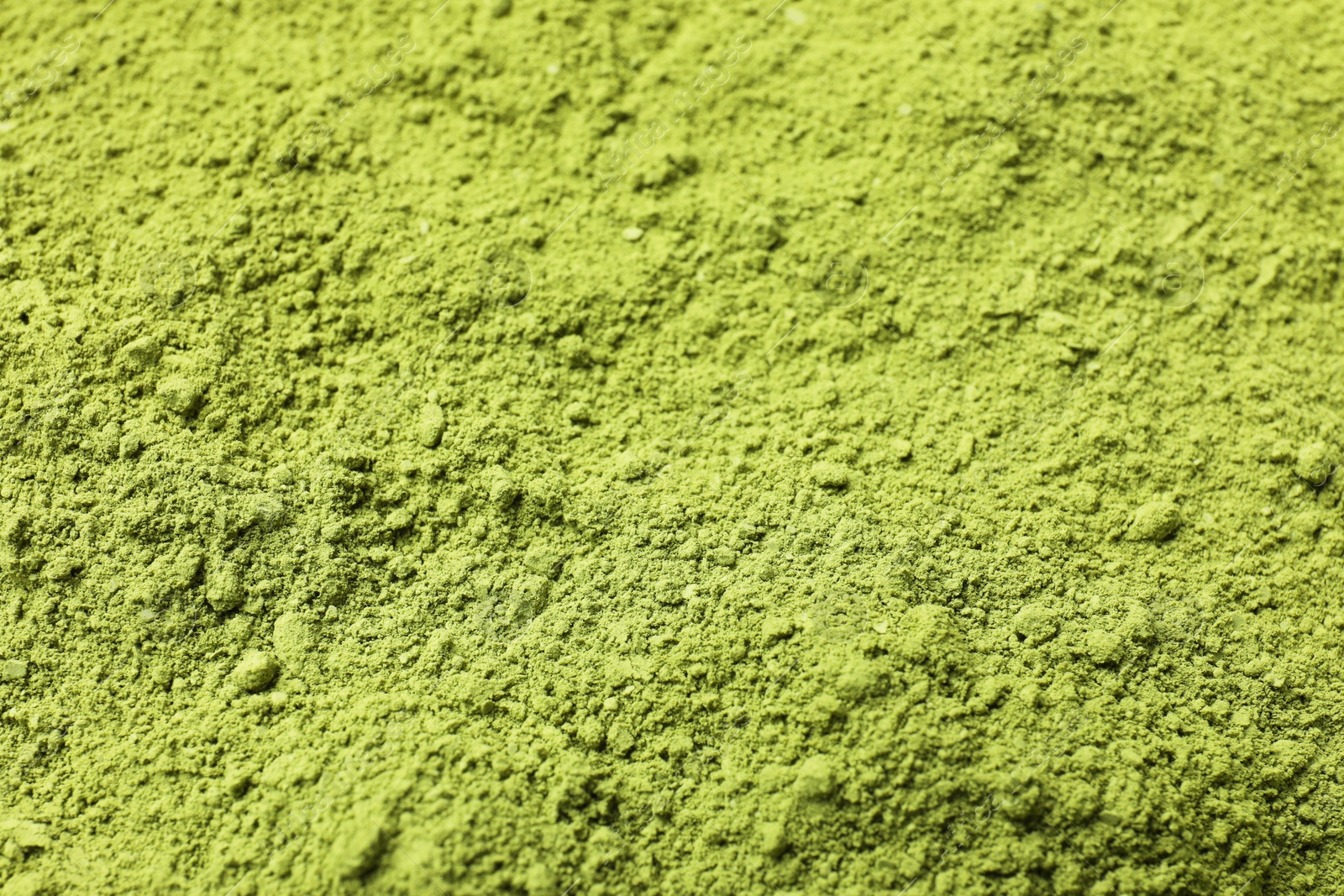 Photo of Green matcha powder as background, closeup view