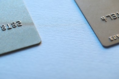 Two credit cards on light background, closeup