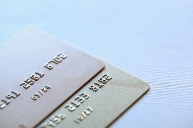 Two credit cards on light background, closeup. Space for text