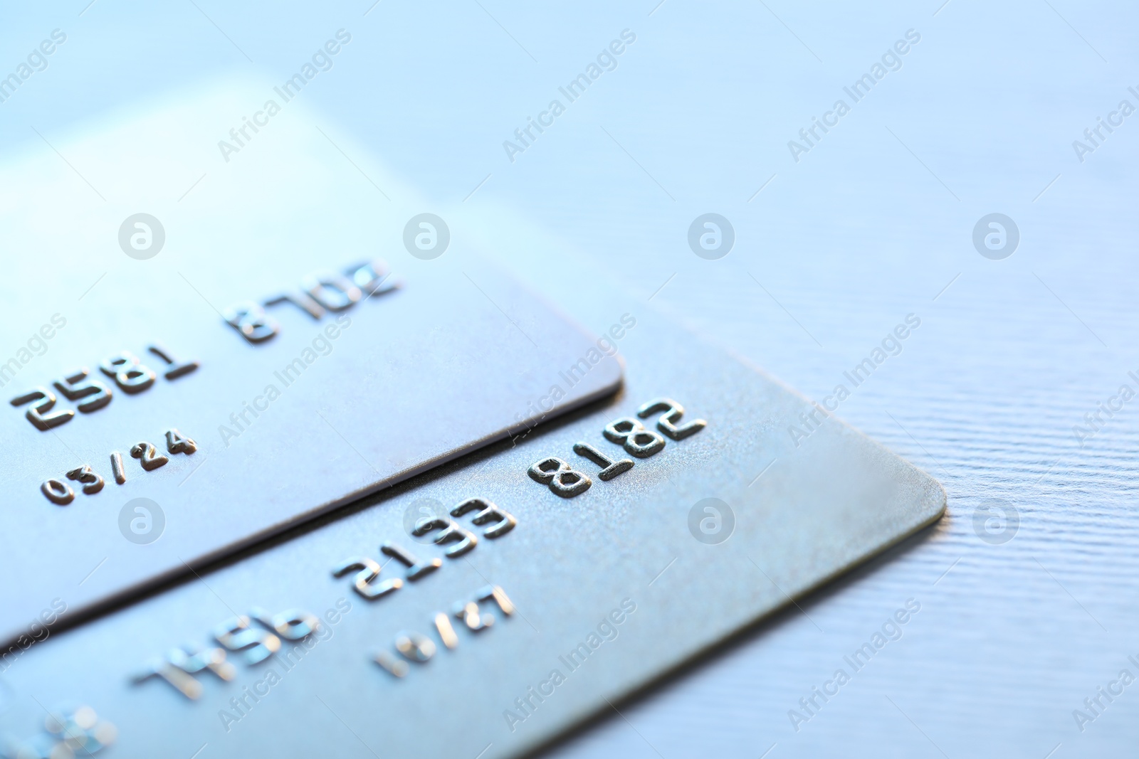 Photo of Two credit cards on light background, closeup