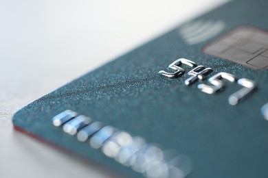 One credit card on light background, macro view