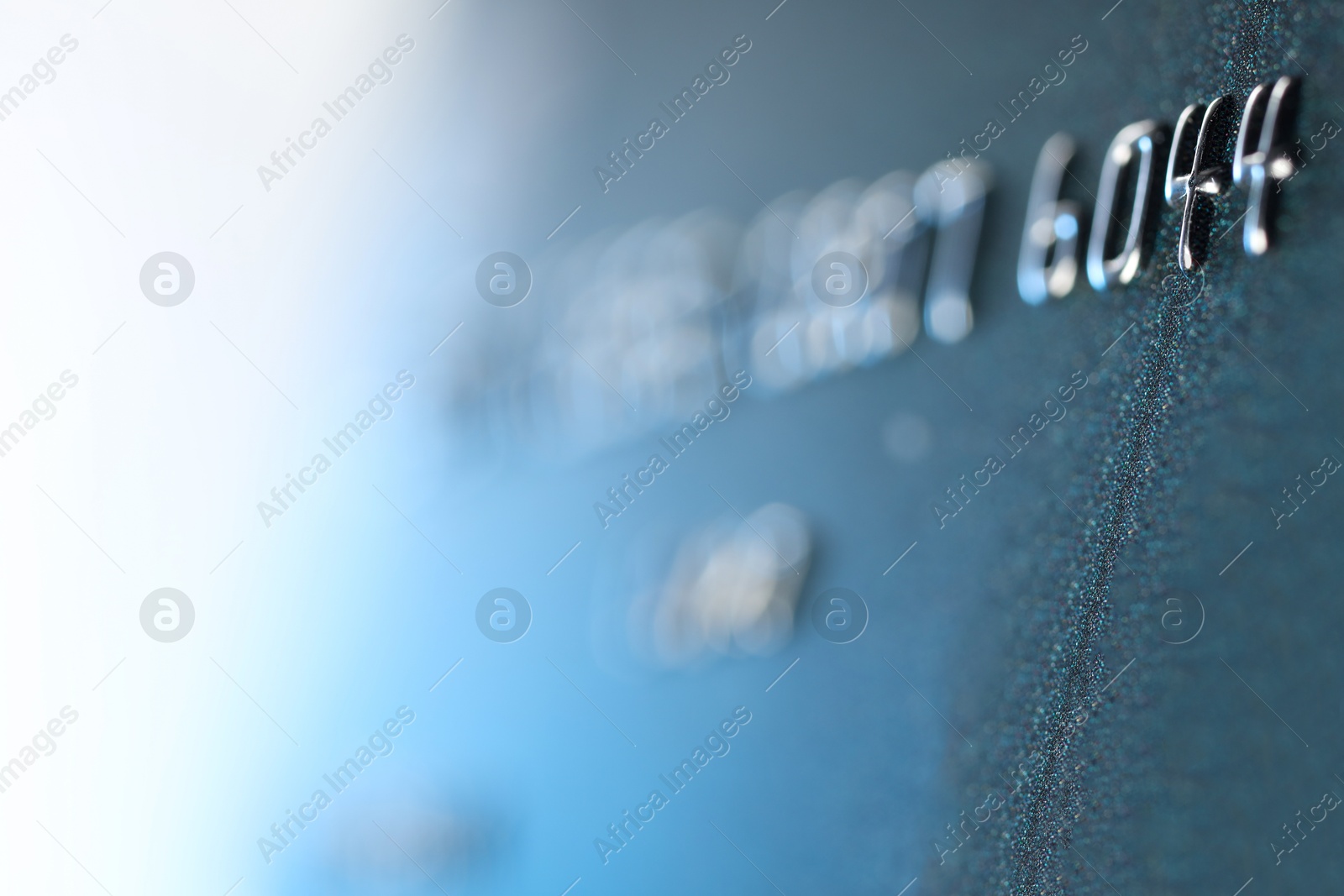 Photo of One credit card on light background, macro view