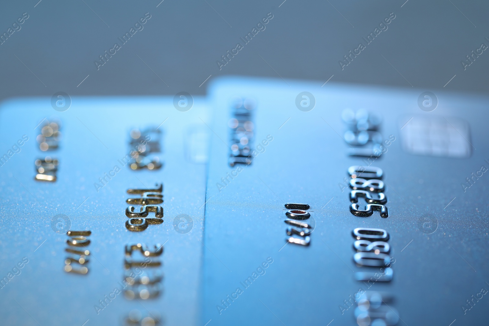 Photo of Credit cards on light blue background, macro view