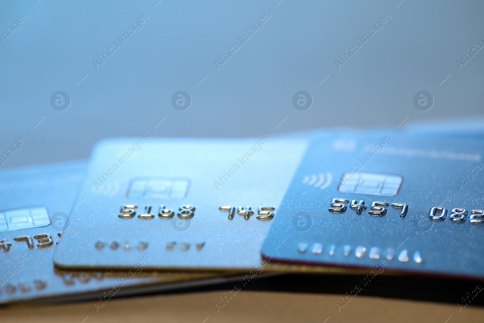 Photo of Many credit cards against blurred background, closeup