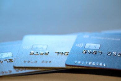 Photo of Many credit cards against blurred background, closeup