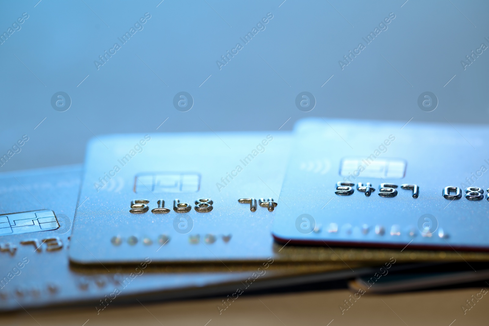 Photo of Many credit cards against blurred background, closeup