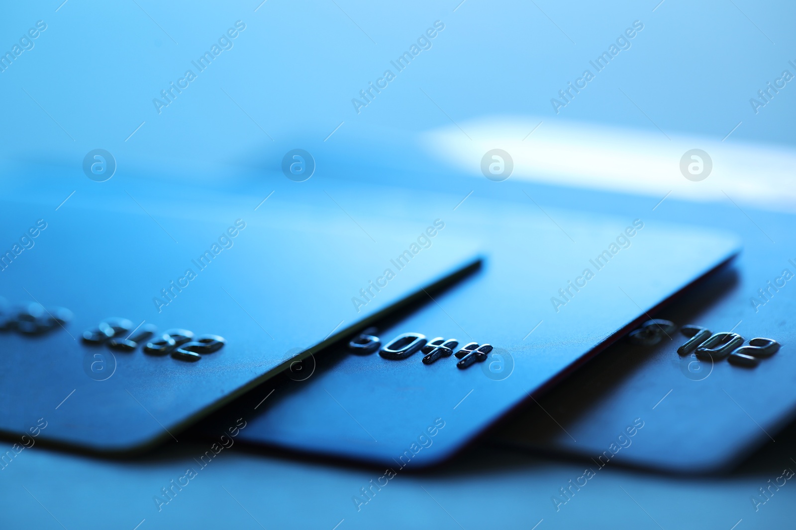 Photo of Many credit cards on blurred background, closeup