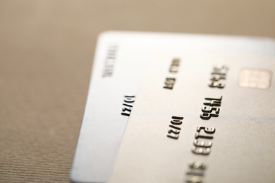 Photo of Two credit cards on beige background, closeup. Space for text