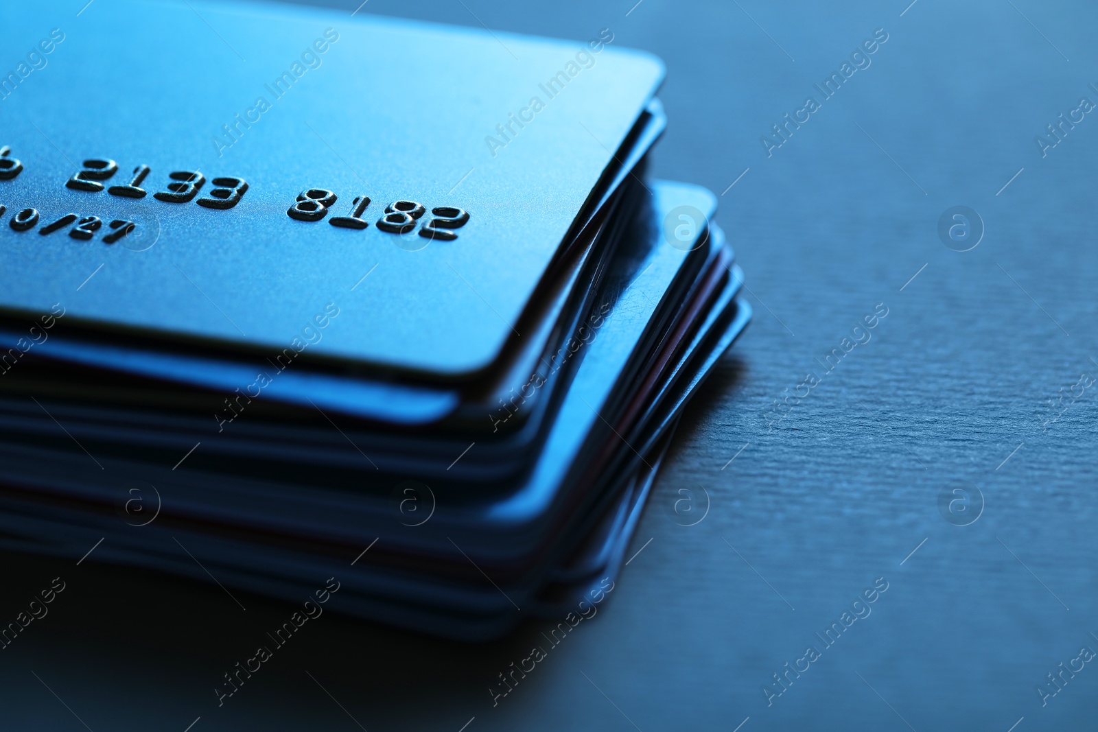 Photo of Many credit cards on table, closeup view