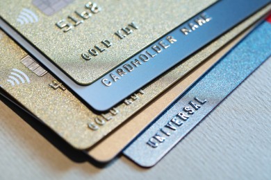 Photo of Many credit cards on gray background, closeup view