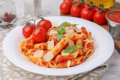 Photo of Tasty pasta with tomato sauce, cheese and basil on table