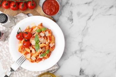 Photo of Tasty pasta with tomato sauce, cheese and basil served on white marble table, top view. Space for text