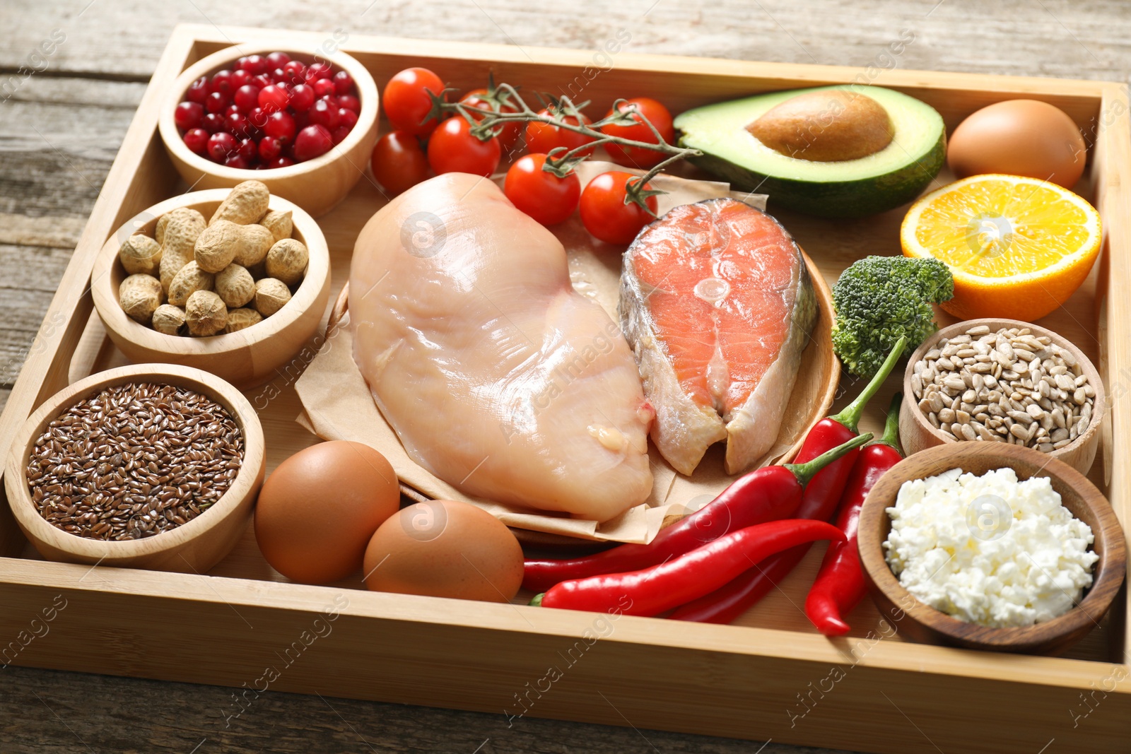 Photo of Tray with many different healthy food on wooden table, closeup