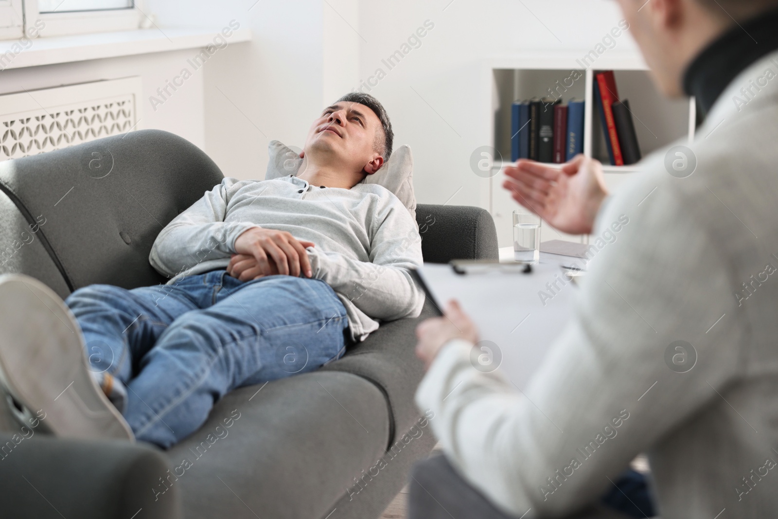 Photo of Professional psychotherapist working with patient in office