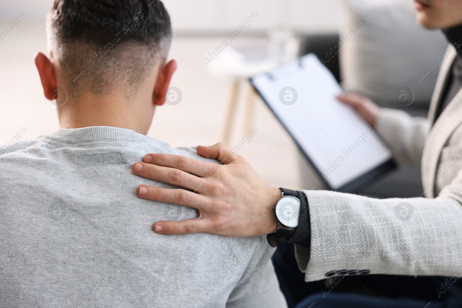 Photo of Professional psychotherapist working with patient in office, closeup