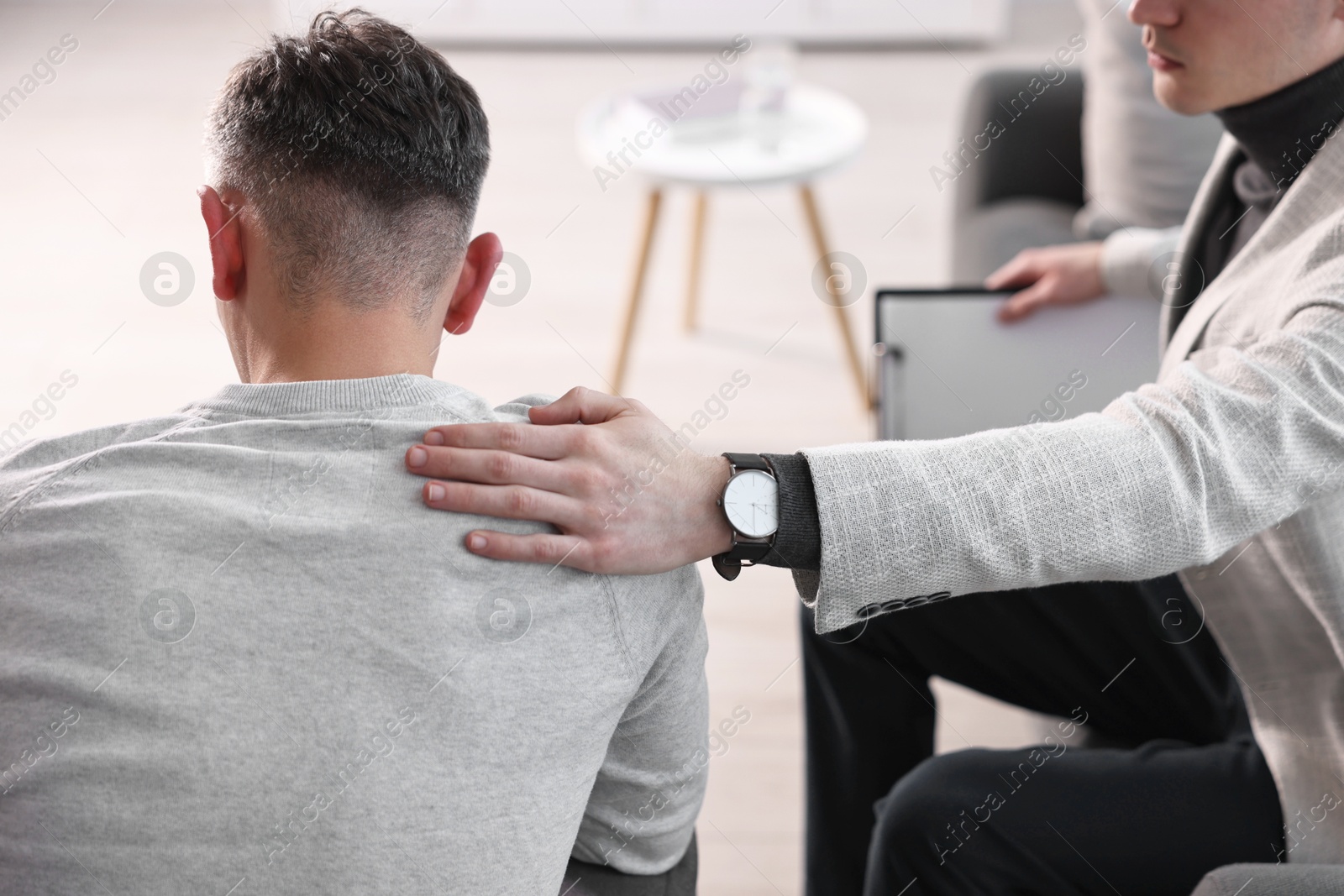 Photo of Professional psychotherapist working with patient in office, closeup