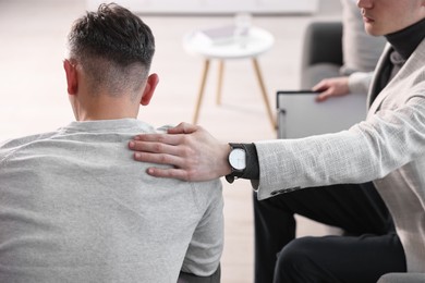 Professional psychotherapist working with patient in office, closeup