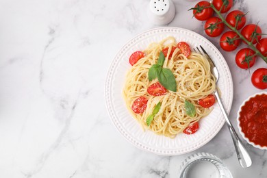 Photo of Tasty pasta with tomato, cheese and basil served on white marble table, flat lay. Space for text