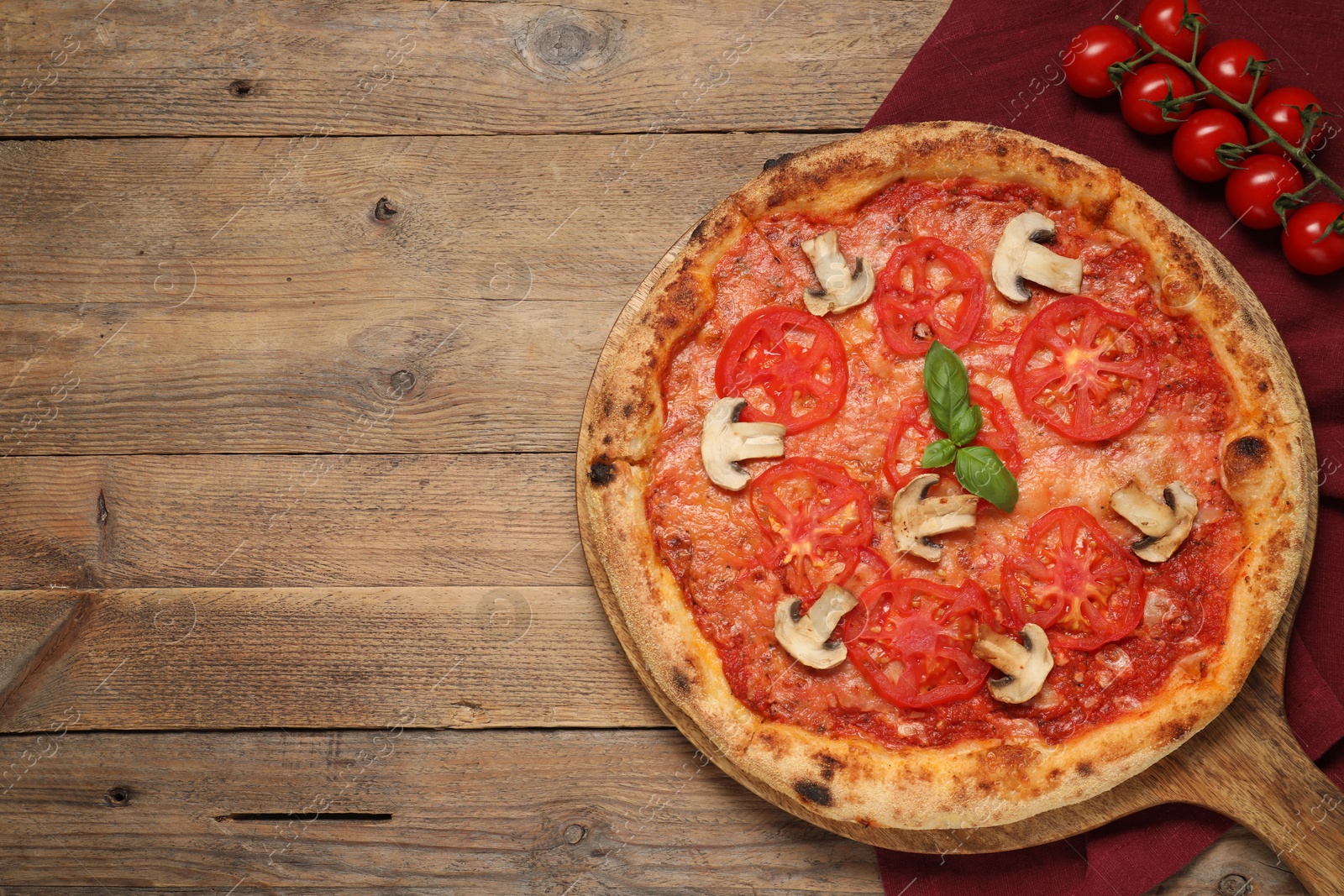 Photo of Delicious pizza with tomatoes, mushrooms and basil on wooden table, flat lay. Space for text