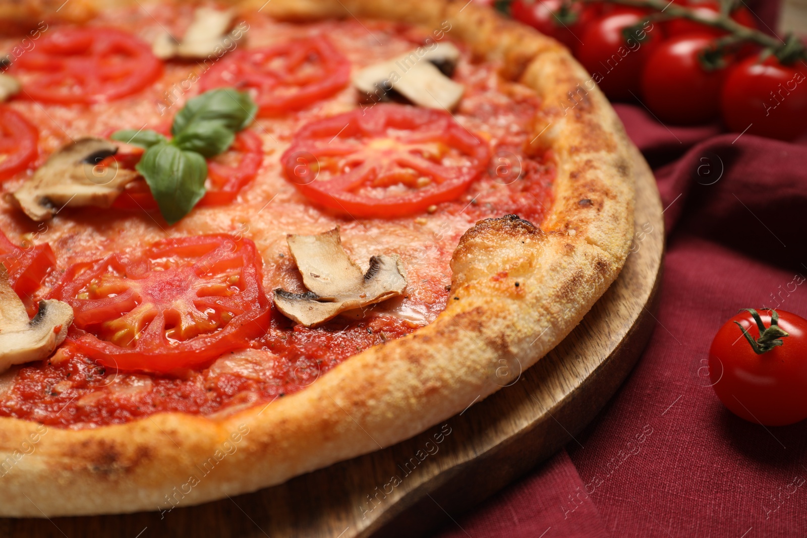 Photo of Delicious pizza with tomatoes, mushrooms and basil on table, closeup