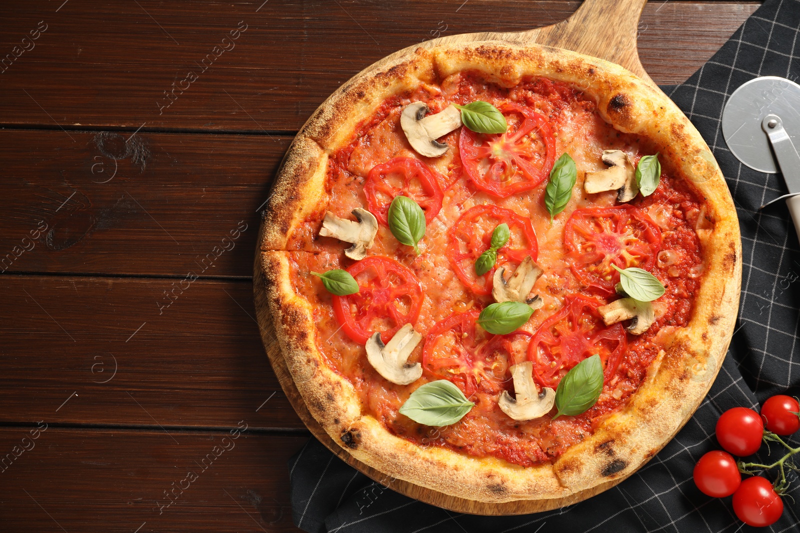 Photo of Delicious pizza with tomatoes, mushrooms and basil on wooden table, flat lay. Space for text