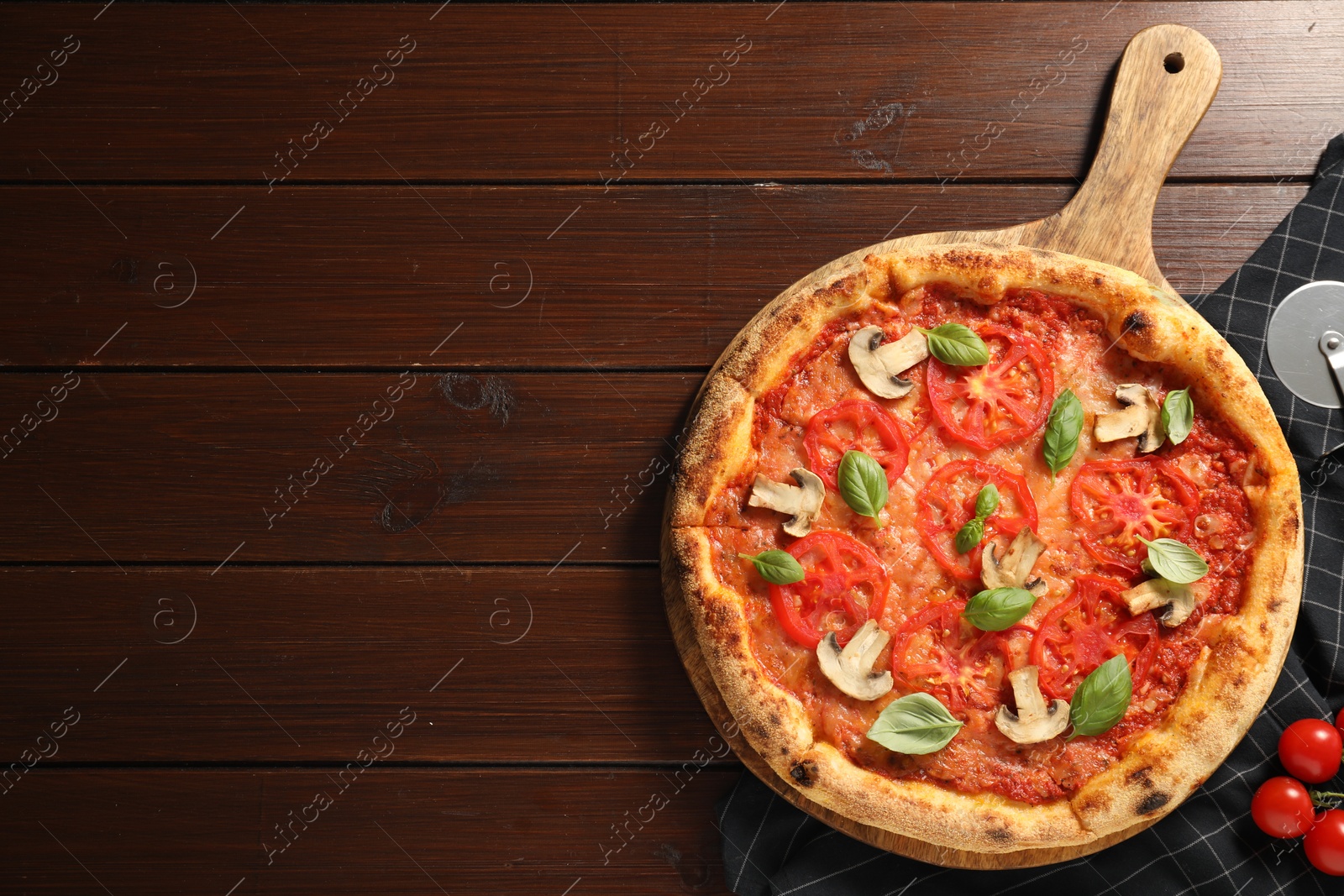 Photo of Delicious pizza with tomatoes, mushrooms and basil on wooden table, flat lay. Space for text