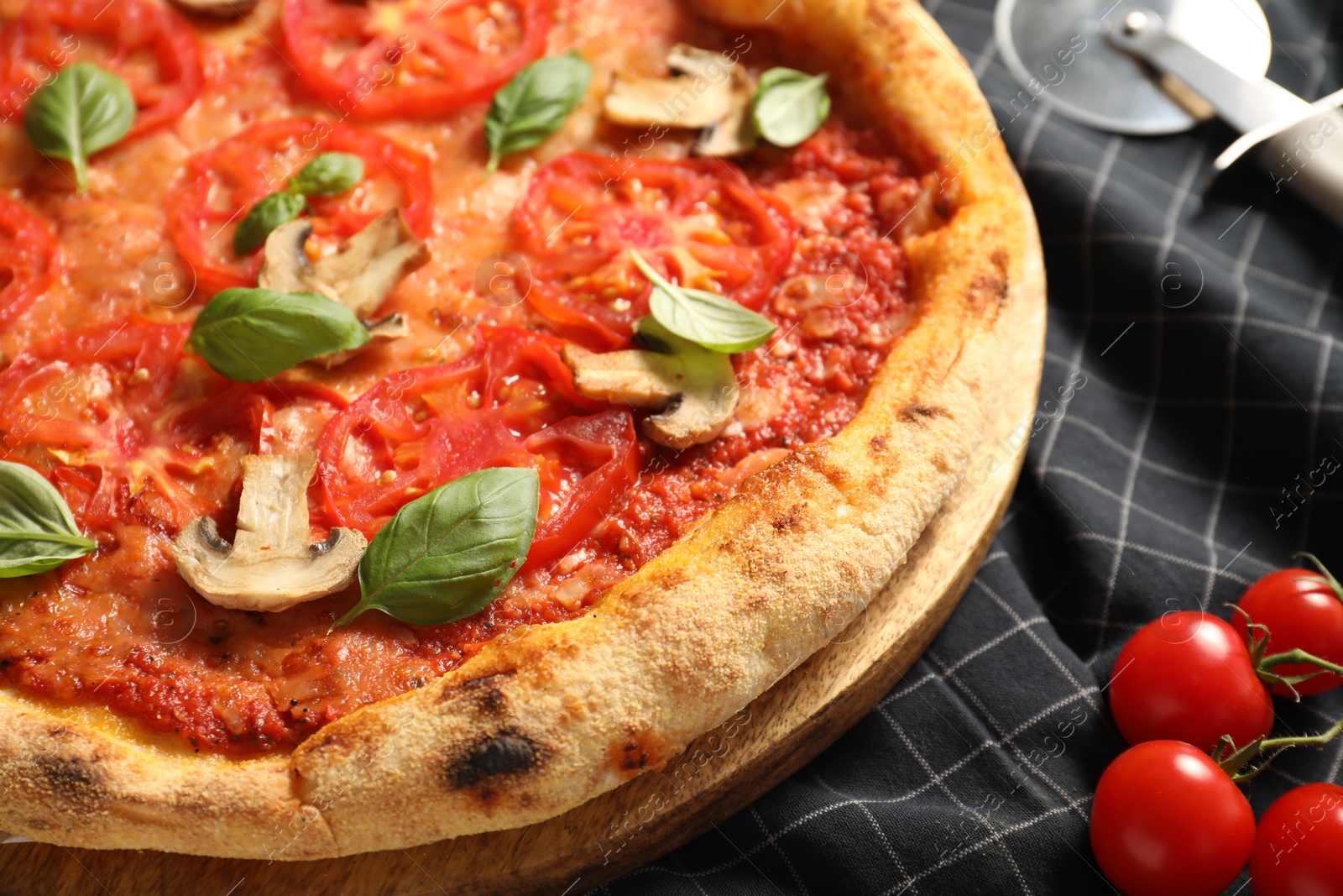 Photo of Delicious pizza with tomatoes, mushrooms and basil on table, closeup