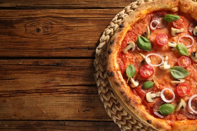 Photo of Delicious pizza with salami, vegetables, mushrooms and basil on wooden table, top view. Space for text