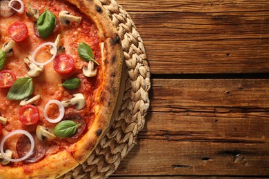 Photo of Delicious pizza with salami, tomatoes, mushrooms and basil on wooden table, top view. Space for text