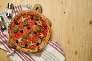 Photo of Delicious pizza with tomatoes, mushrooms, black olives and basil on wooden table, top view. Space for text