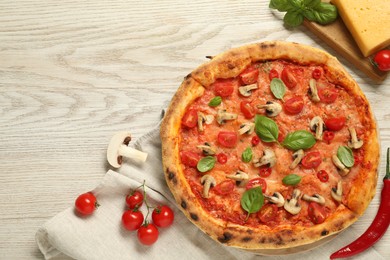 Photo of Delicious pizza with tomatoes, mushrooms and basil on wooden table, flat lay. Space for text