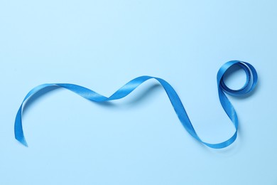 Beautiful bright ribbon on light blue background, top view