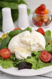 Photo of Delicious fresh burrata salad on white table, closeup