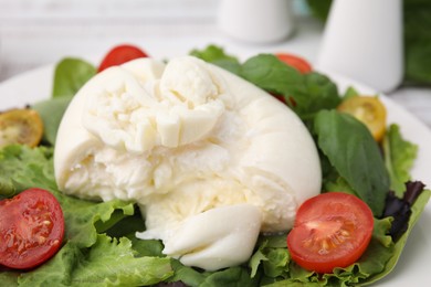 Photo of Delicious fresh burrata salad on table, closeup