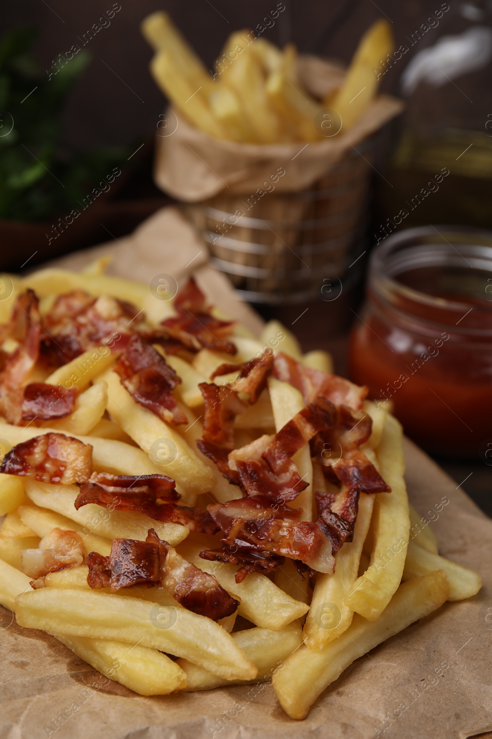 Photo of Delicious French fries with slices of bacon on table, closeup