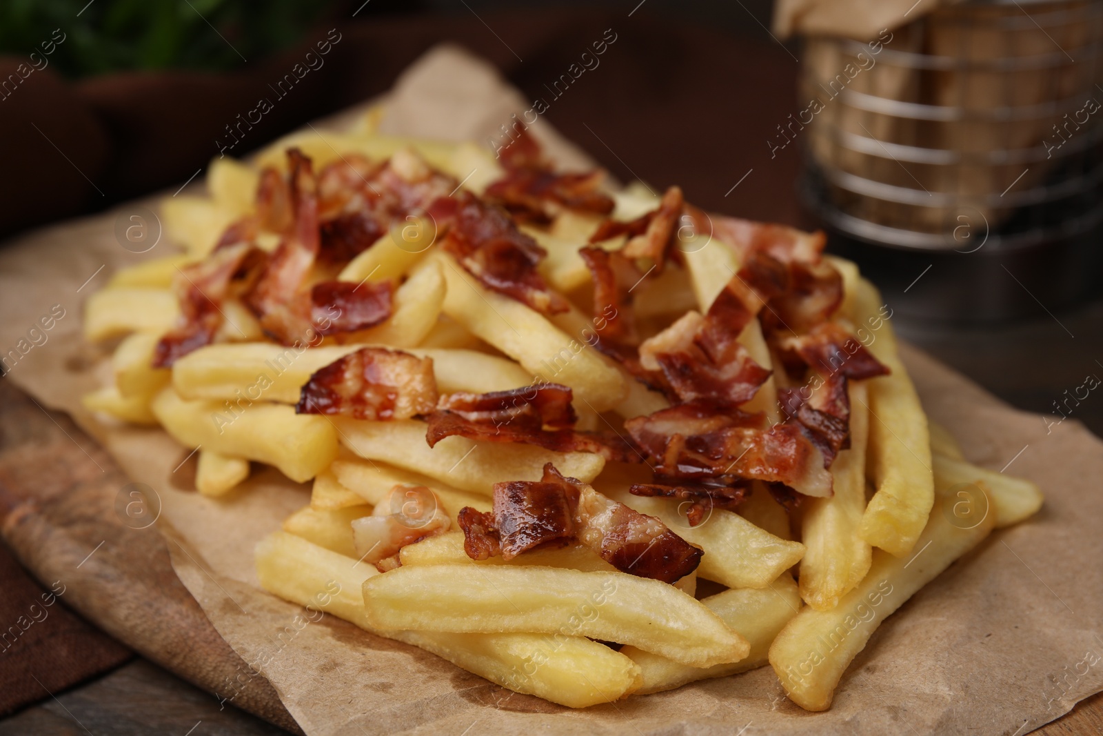 Photo of Delicious French fries with slices of bacon on table, closeup