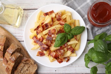 Delicious French fries with bacon, basil and ketchup on wooden rustic table, flat lay