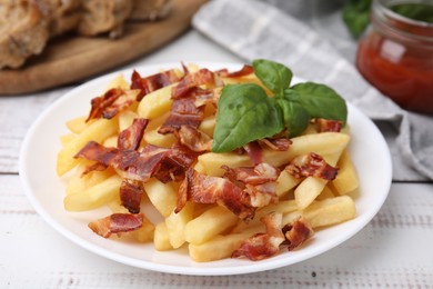 Photo of Delicious French fries with slices of bacon and basil on wooden rustic table, closeup