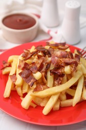 Delicious French fries with slices of bacon on white tiled table, closeup