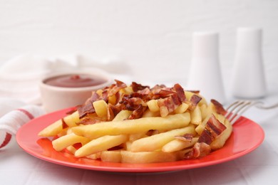 Photo of Delicious French fries with slices of bacon on white tiled table, closeup